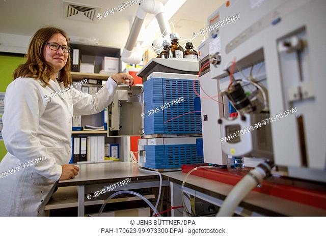Chemist Kathrin Fisch looks at a water sample from the Baltic Sea at the Leibniz Institute for Baltic Sea Research in Rostock, Germany, 23 June 2017