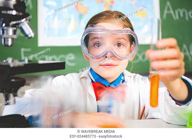 Schoolgirl doing a chemical experiment in laboratory