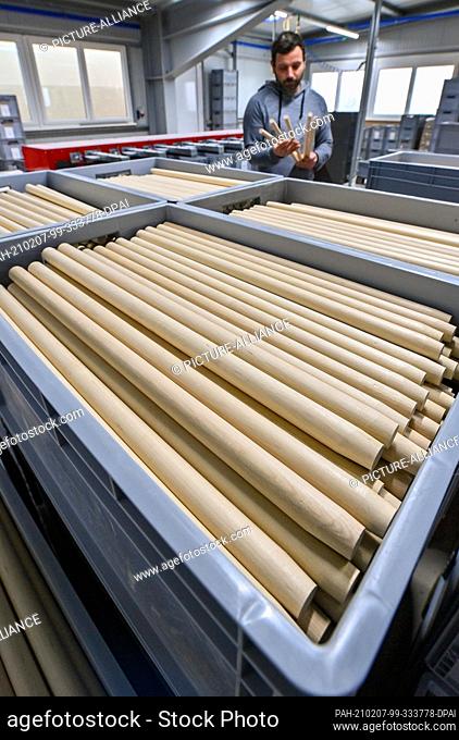 28 January 2021, Saxony, Markneukirchen: Denny Liebel, production manager, controls the manufacture of drumsticks in the production of Rohema Percussion in...