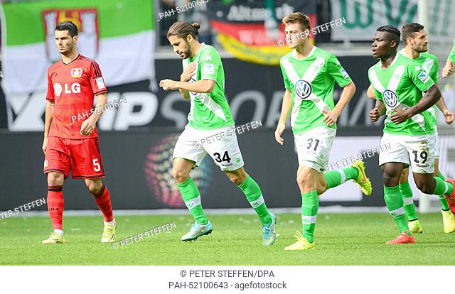 Wolfsburg's Ricardo Rodriguez (2nd from L) celebrates his 1:0 goal against Bayer 04 Lverkusen with teammates Robin Knoche (3rd from L) and Junior Malanda