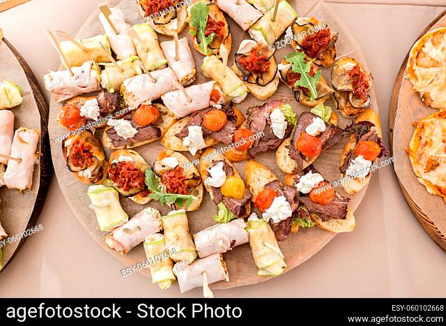 Assorted canape with cheese, meat, rolls, bakery and vegetables. Food to accompany the drinks. the buffet at the Banquet