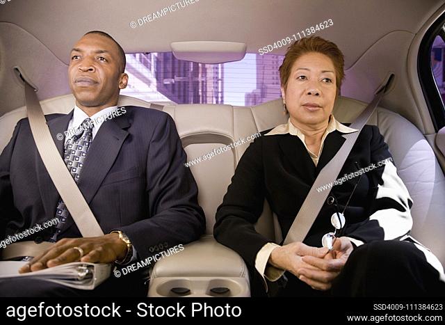 Business people in back seat of car