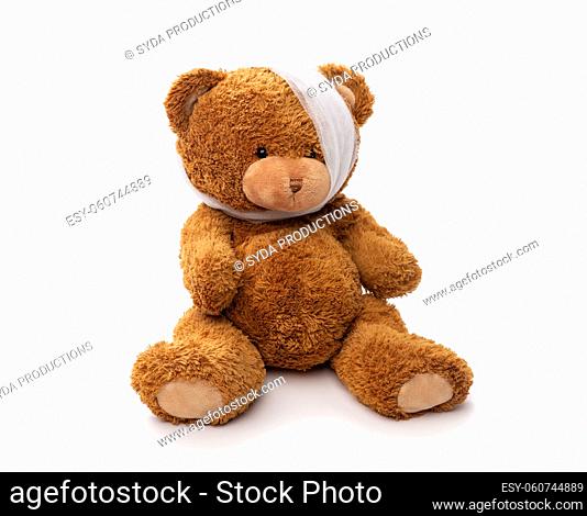 teddy bear toy with bandaged head having toothache