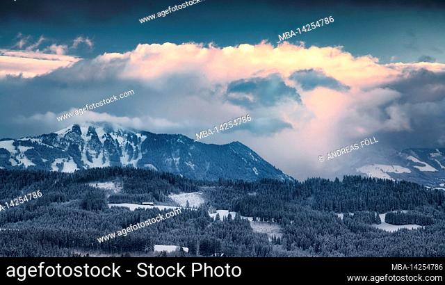 Dramatic clouds over the Grünten and the Allgäu Alps on a cold winter evening. Bavaria, Germany, Europe