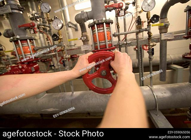turning a valve in the heating system of a building