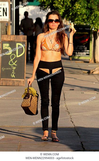 'Hoarding: Buried Alive' star Alicia Arden poses for pictures while shopping on Melrose Avenue and eating a banana. She is wearing R-Rated XPOZ Jeans with front...