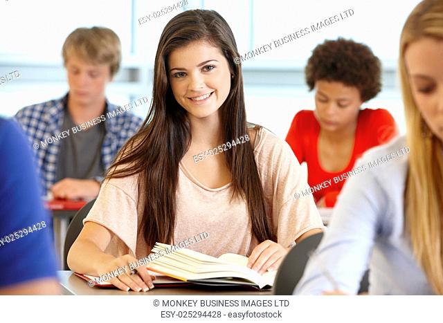 Teenage girl in class smiling to camera
