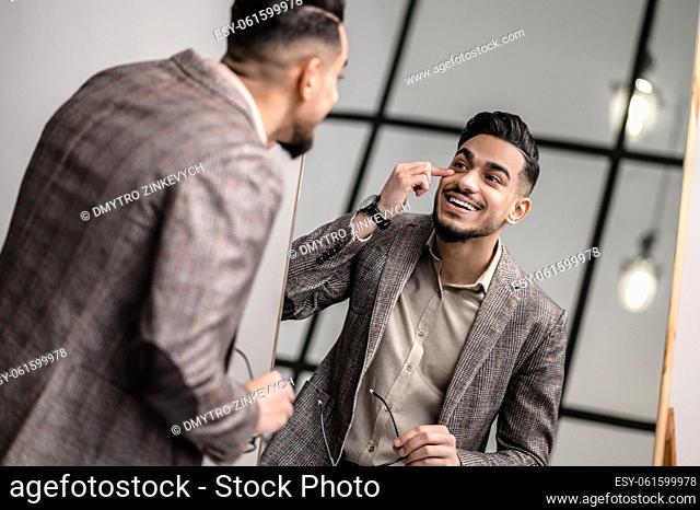 Elegant man. A good-looking young elegant man at the mirror