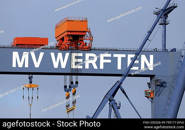 04 February 2020, Mecklenburg-Western Pomerania, Rostock: The lettering ""MV Werften"" on the gantry crane at the Warnemünde location of MV Werften