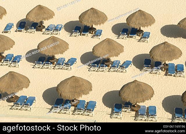 Beach umbrella of armchairs in the sand of Cancun
