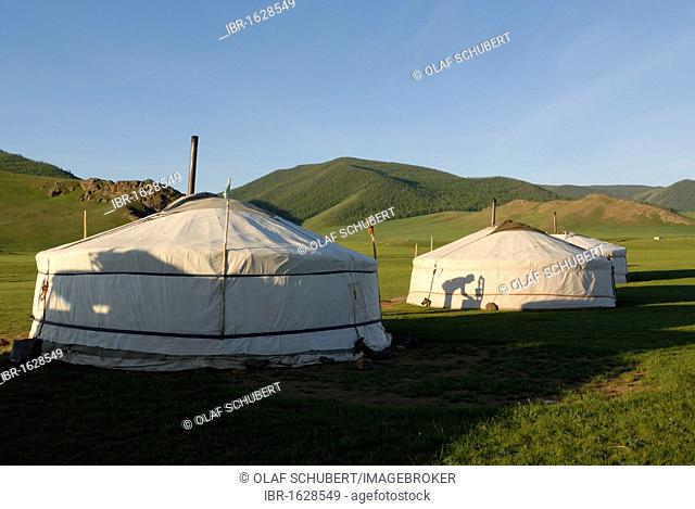 Yurt camp or ger camp in the grasslands at the Orkhon Waterfall in front of the mountains of the Khuisiin Naiman Nuur Nature Reserve, Orkhon Khuerkhree