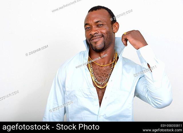 Studio shot of handsome bearded African man as gangster against white background