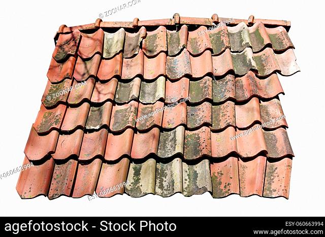 Fragment of a broken clay tiled roof of a village barn. Isolated on white