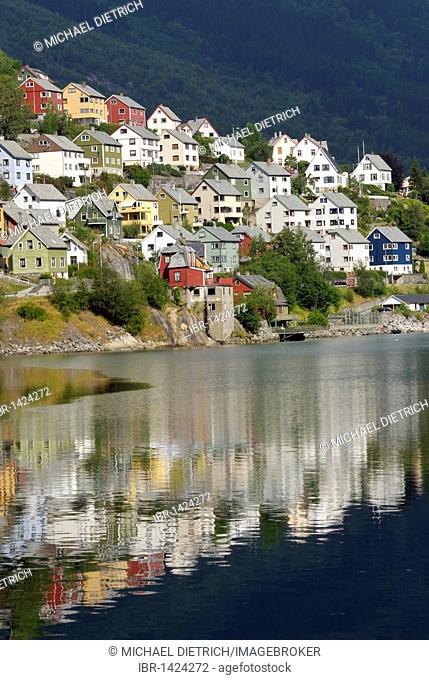 Houses reflecting in the water of the Sørfjord, Odda, province of Hordaland, Norway, Europe