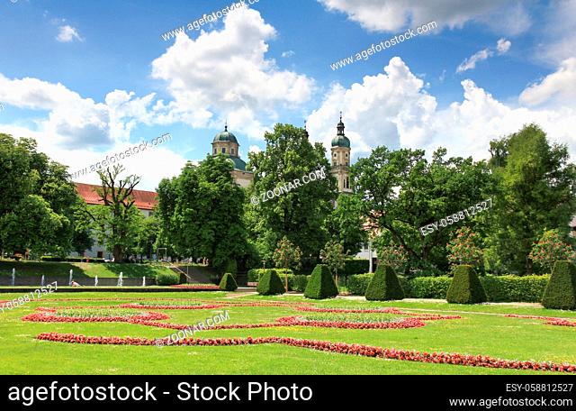 Blooming court garden in spring with church and trees in background. Kempten, Bavaria, Germany