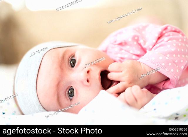 Close-up portrait of a beautiful baby on bright background. New born concept