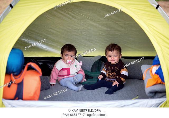 Two Syrian refugee children sit in a tent in a camp at the Greek-Macedonian border located ten kilometres away from Idomeni, Greece, 08 March 2016