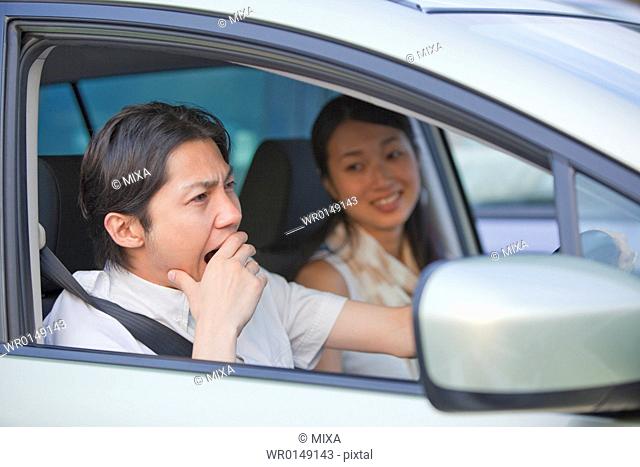 Young Man Yawning at Drivers Seat