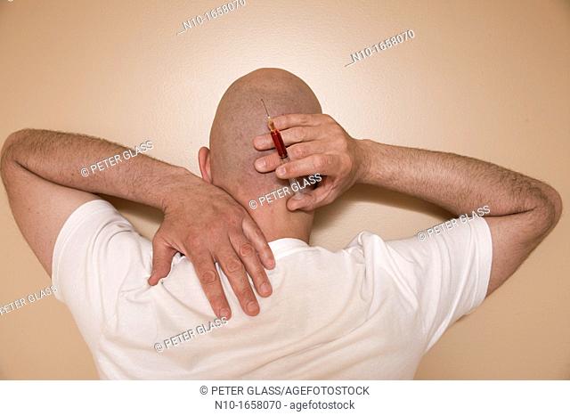 Middle-age bald man holding a syringe