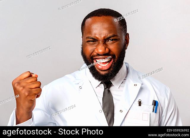 Healthcare, medicine and hospital treatment concept. Close-up portrait of triumphing, rejoicing african-american doctor finally fought disease got positive test...