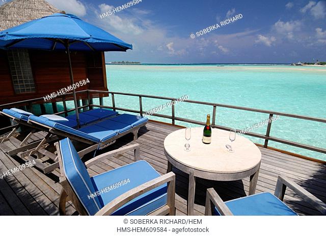 Maldives, South Male Atoll, Dhigu Island, Anantara Resort and Spa Hotel, bungalows with terrace overlooking the lagoon with a bottle of champagne