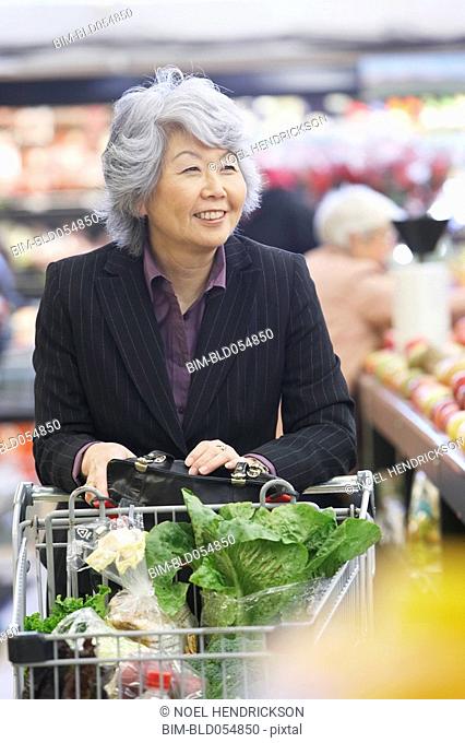 Senior Asian woman in grocery store