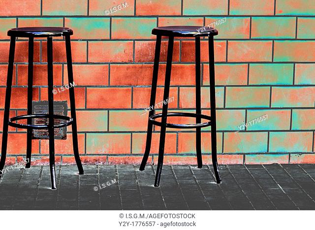 Brick wall with chairs