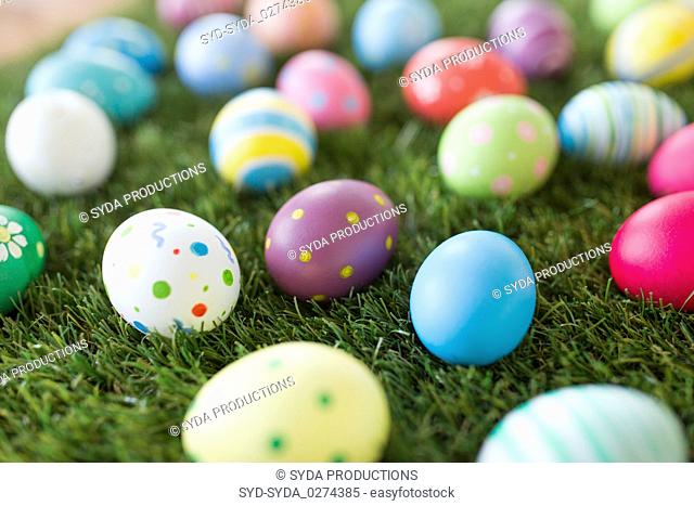 colored easter eggs on artificial grass