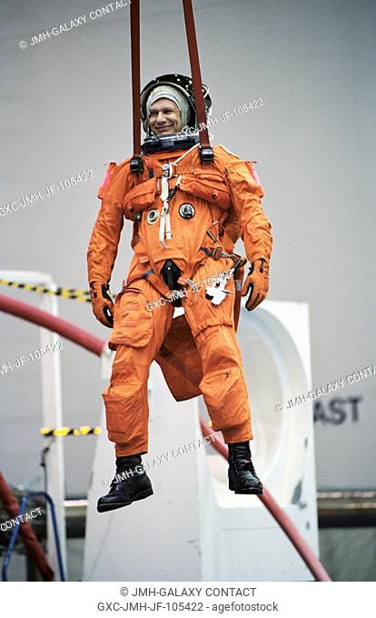 Astronaut Piers J. Sellers, STS-112 mission specialist, simulates a parachute drop into water during an emergency bailout training session at the Neutral...