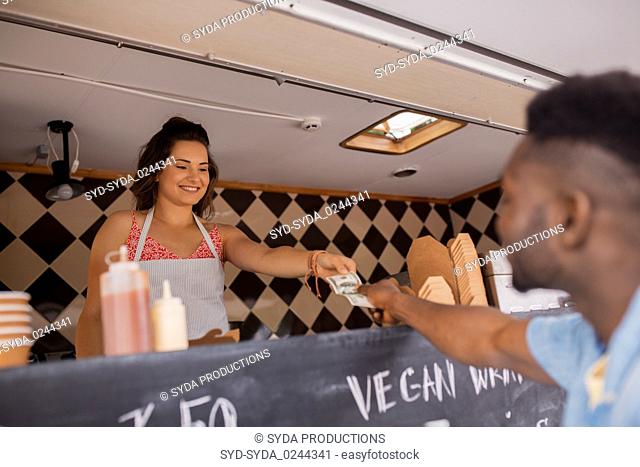 african american man buying wok at food truck