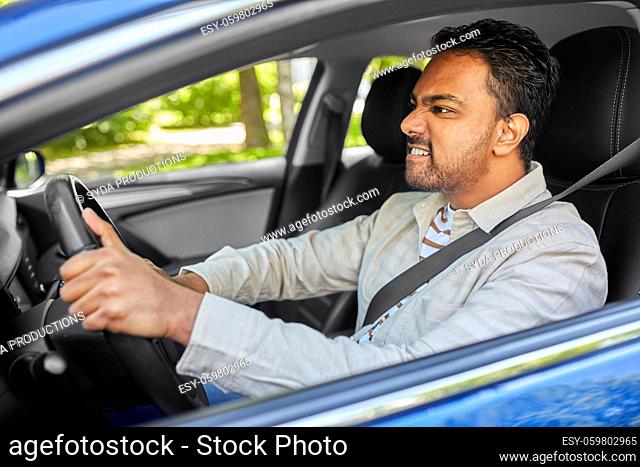angry indian man or driver driving car