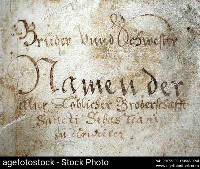 27 July 2022, Rhineland-Palatinate, Mainz: Part of the title page of the historical book of souls of the St. Sebastianus-Bürger-Schützengesellschaft Ahrweiler