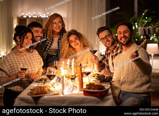 friends taking selfie at christmas dinner party