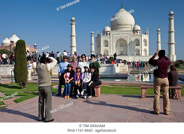 Tourists taking photographs at The Taj Mahal mausoleum southern view Uttar Pradesh, India