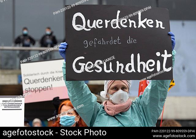 19 January 2022, Hessen, Offenbach: Against a simultaneous march of about 5000 opponents of the current Corona measures, these demonstrators take part in the...