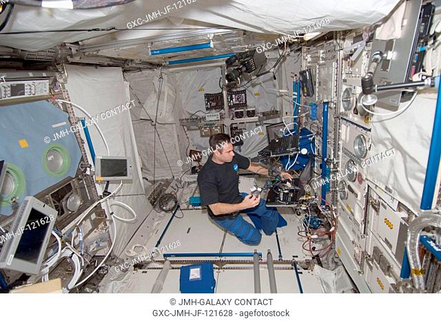 NASA astronaut Greg Chamitoff, Expedition 17 flight engineer, works with an experiment in the Columbus laboratory of the International Space Station
