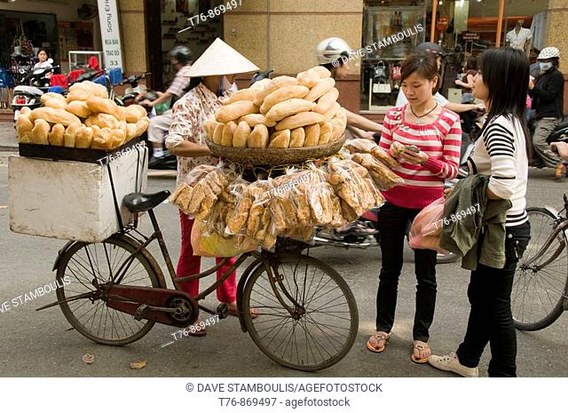 French baguette vendor on the streets of Hanoi Vietnam