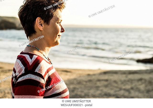 France, Crozon peninsula, Portrait of mature woman at beach