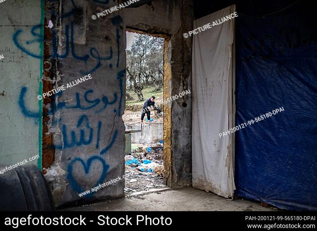 21 January 2020, Greece, Lesbos: A migrant washes his clothes in a temporary camp next to the camp in Moria. The camps on the islands of Lesbos, Samos, Chios