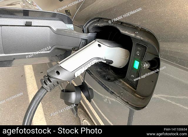 Plug during the charging process on an e-car, electric car-e-car is being charged, charging plug, charging cable, charging column, charging socket, e-mobility