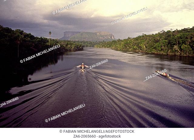 Aerial view of tourist boats going up Carrao river showing tepuis in the bakground. Canaima National Park, Bolivar State, Southern Venezuela
