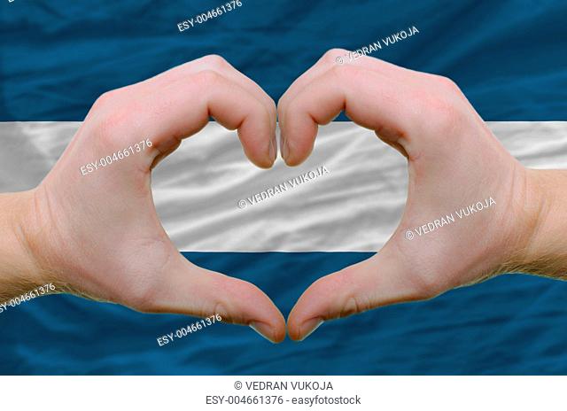 Heart and love gesture showed by hands over flag of el salvador