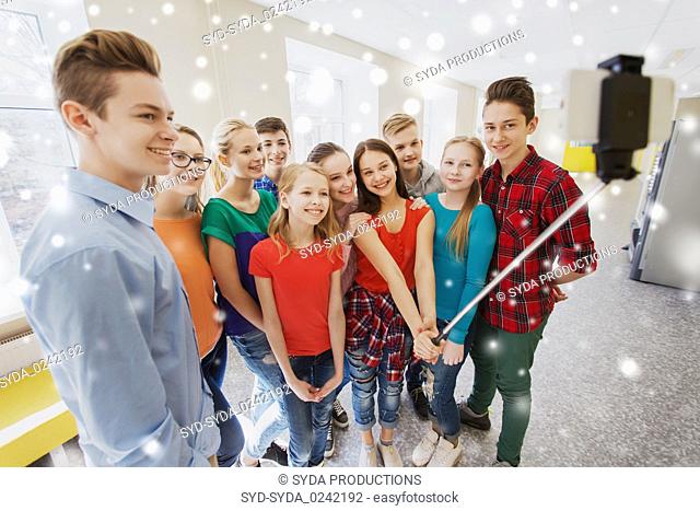 group of students taking selfie with smartphone