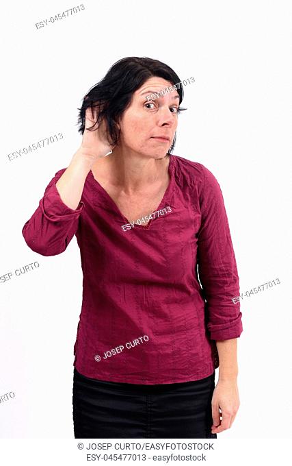 woman putting a hand on her ear because she can not hear on white background