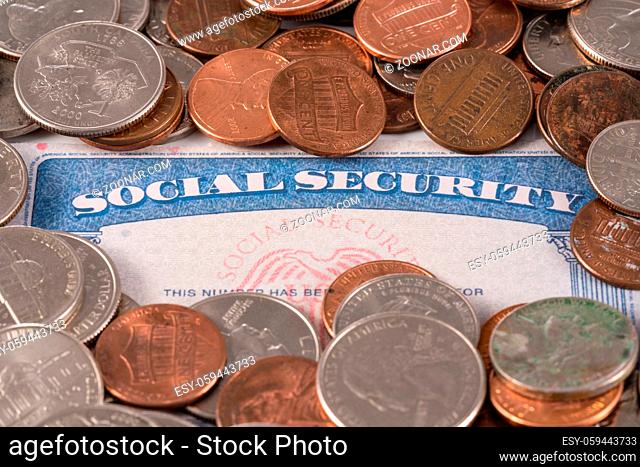 USA social security card with coins and cash to show funding crisis in the trust fund