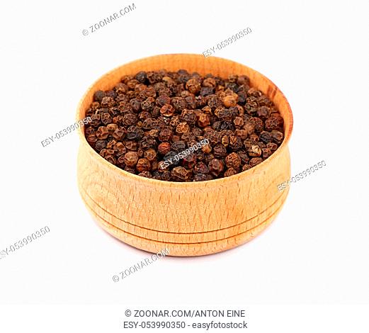 Close up one wooden bowl full of black pepper peppercorns isolated on white background, high angle view