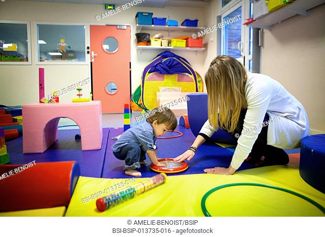 Reportage on a psychomotor specialist practising in a day nursery in Paris, France. This small 2-year old boy has a delayed growth rate and has psychomotor...