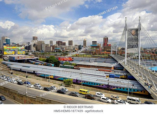 South Africa, Gauteng province, Johannesburg, Nelson Mandela bridge over train carriages at Park Station and Johannesburg CBD (Central Business District) seen...