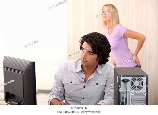 man and woman looking at a computer