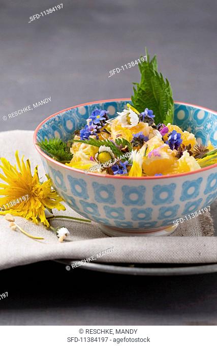 Orange and apple salad with hazelnuts and edible flowers